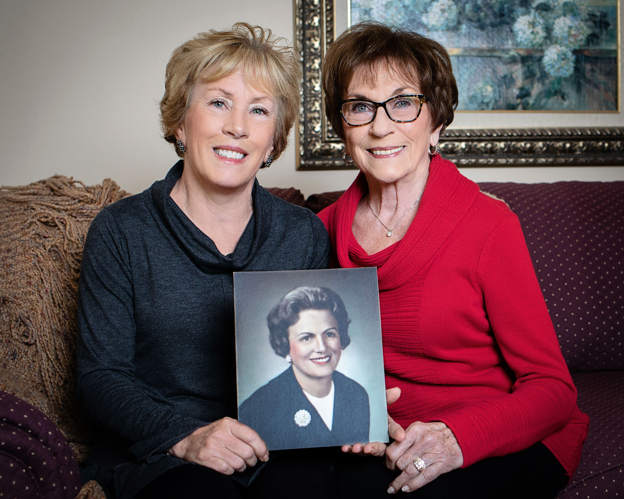 two women holding photo of another woman