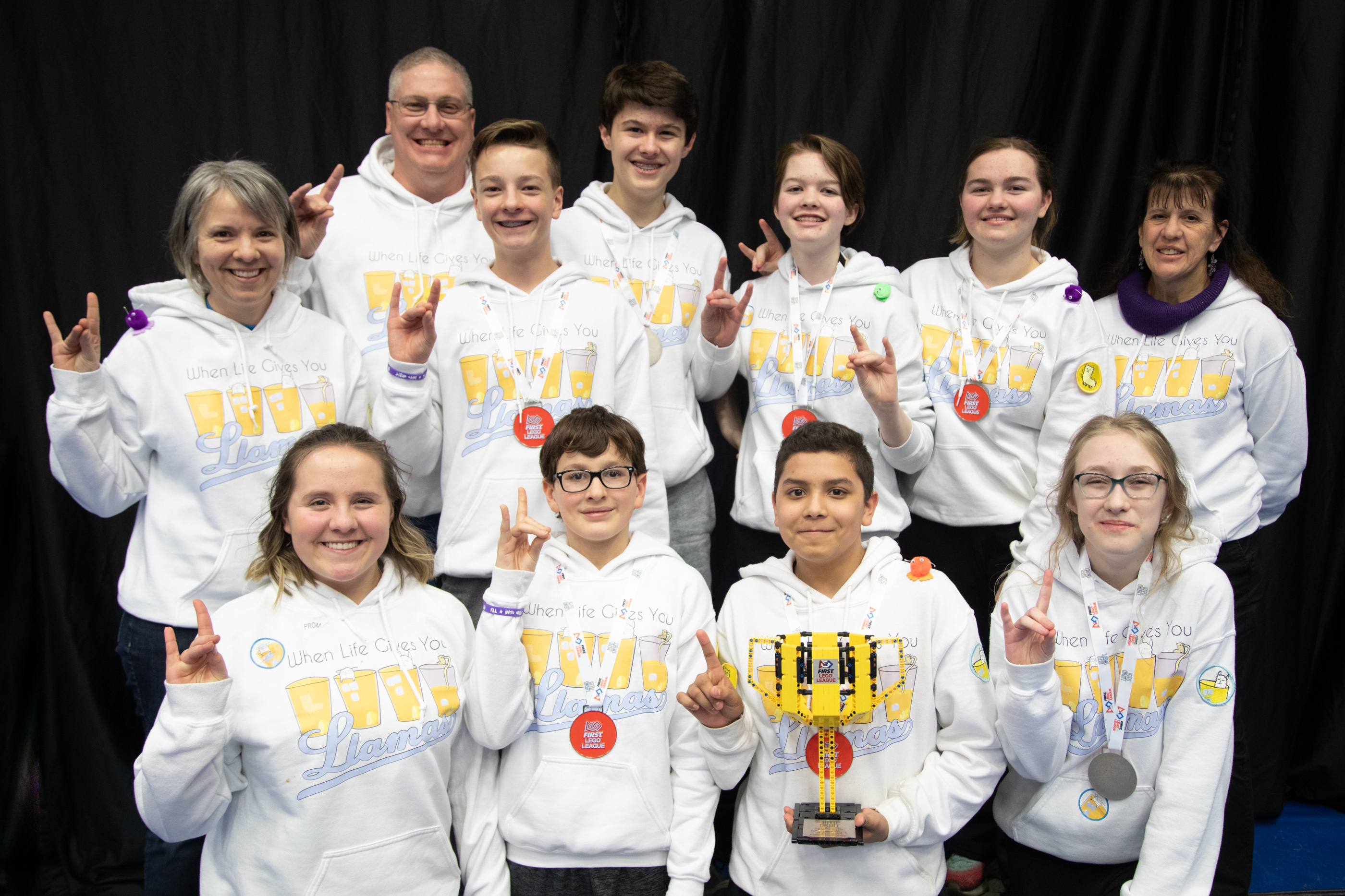 Team Smiling and Showing off their Trophy