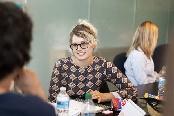 Lady with blonde curly hair having a discussion